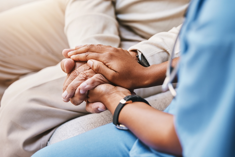 Nurse,Holding,Hands,With,Patient,In,Empathy,,Trust,And,Support background