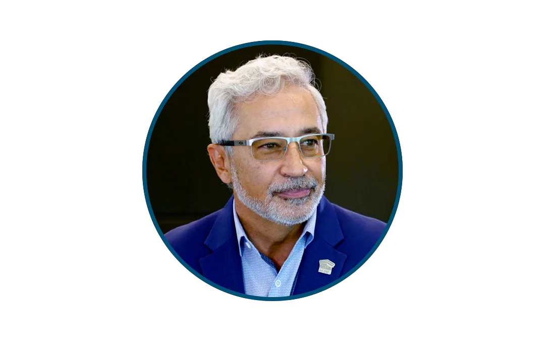 Jose_2026 | ACHC.ORG Portrait of a middle-aged man with gray hair and glasses wearing a blue blazer and light blue shirt, facing slightly to the right.
