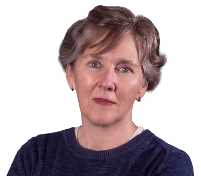 Portrait of a middle-aged woman with short gray hair, wearing a navy sweater, looking at the camera in a studio setting.