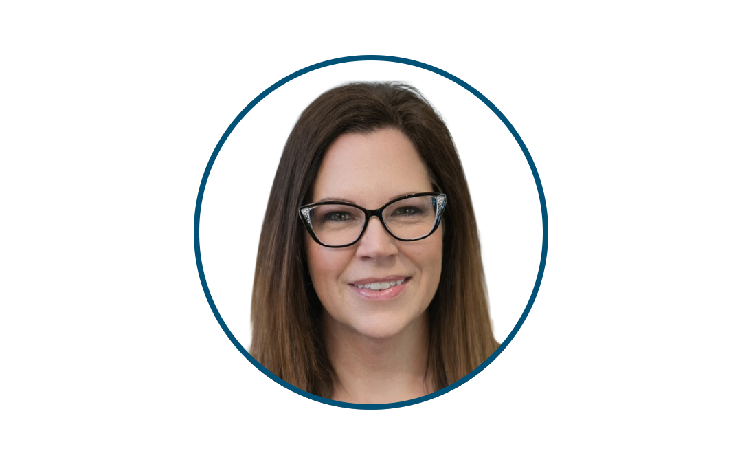Smiling woman with brown hair and black glasses, headshot inside a blue circular frame.