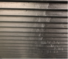 Vents | ACHC.ORG Close-up of brown metal Venetian blind slats with a chalky vertical streak running down the middle.